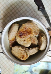 Fried meatballs in a pan on the kitchen table