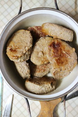 Fried meatballs in a pan on the kitchen table