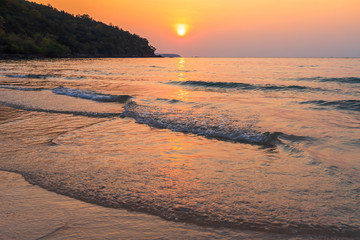 Fototapeta premium Beautiful early sunset over and Wave of the sea on the sand beach the horizon Summer time at hat sai kaew beach in Chanthaburi Thailand.