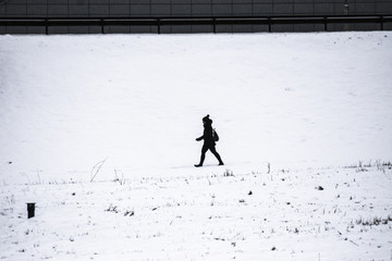 Person walking through the white snow