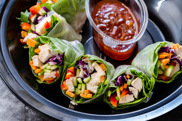 Take Away Healthy Asian Vietnamese Spring Roll / Goicuon with Rice Paper Rolls and Red Hot Chili Sauce in Plastic Container Plate Package or Box.