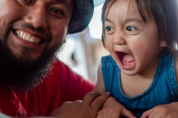 Krabi, Thailand - January 21, 2019: Portrait of malay toddler and bearded father.