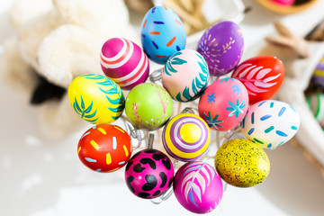 Fototapeta na wymiar Easter holiday concept,Colorful Easter eggs in egg box,basket Easter eggs on white pastel color rustic wood background with space.