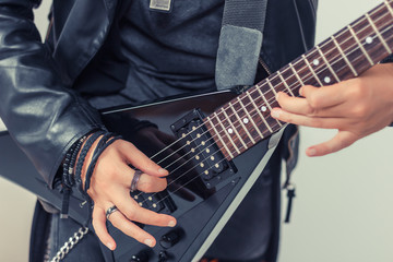 Fototapeta na wymiar Close-up of man playing electric guitar.
