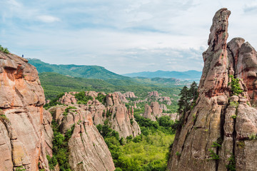 View of a picturesque green valley filled with yellow-red rocks with whimsical shapes, Belogradchik...
