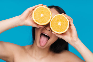 Optimistic asian young woman with orange.