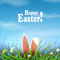 Easter composition with blue sky with white clouds, bunny ears, flowers and green grass