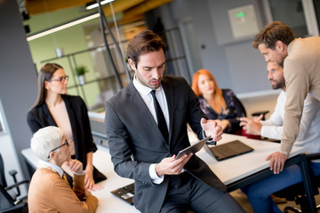 Young businessman using digital tablet in office
