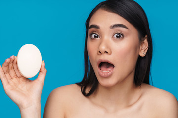 Surprised young woman posing isolated