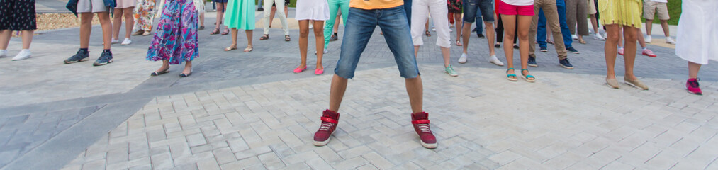 Social dance and flashmob concept - Fun and dance with in the summer on a city street. Close-up of dancers feet.