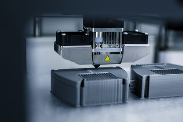 Modern technical 3D printing. Electronic three dimensional plastic printer during work.