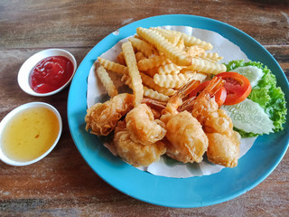 Fried shrimp with french fries and salad