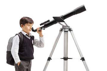 Boy in a school uniform looking through a telescope
