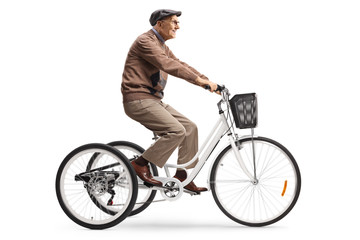 Naklejka premium Senior man riding a tricycle
