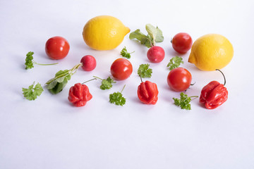 tomato, lemons and peppers lie on a table