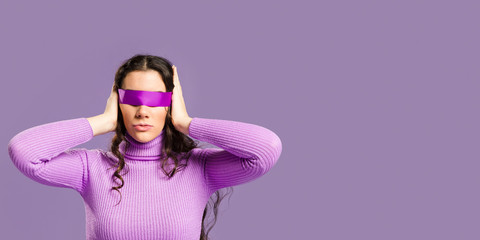 Woman with her eyes covered and copy space - obrazy, fototapety, plakaty