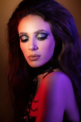 Colorful portrait of a young retro woman under color background