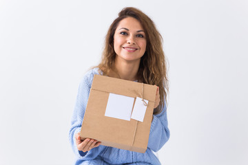 Online shopping, delivery and fashion concept - Woman sitting on sofa at home holds online clothing purchase