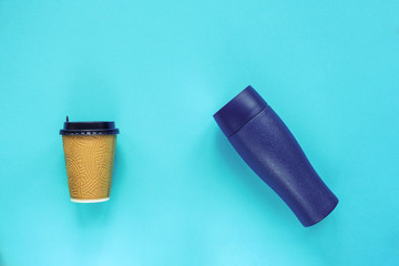 Disposable and reusable coffee containers on blue background. Zero waste, green and conscious lifestyle concept. Top view, flat lay.