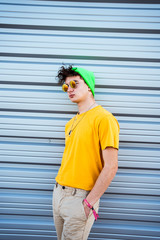 Portrait young guy with urban style and cool with hat and sunglasses. Young millennial lifestyle...