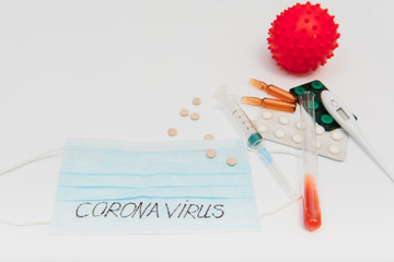 Test tube with the inscription 2019 – nCoV , syringe, tablets and faceband. coronavirus infection.