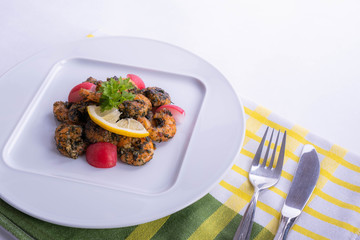on the table a dish of shrimp on a white plate