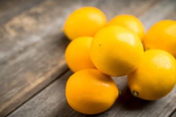 Fresh ripe lemons on the rustic background. Selective focus. Shallow depth of field.