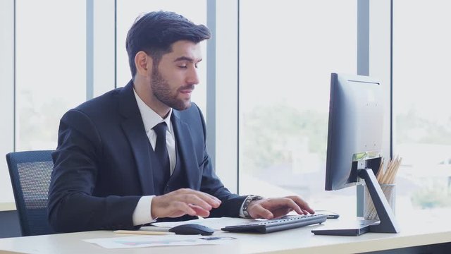 Smart businessman working with computer in the modern office.