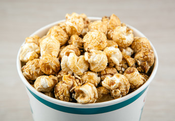 big cardboard cup with golden sugar popcorn