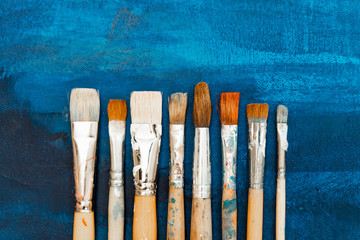 Tools and equipment for the artist. Palette and brushes close-up. The process of drawing and...