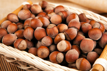 whole hazelnut kernels in a wicker basket still life