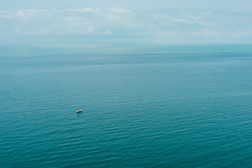 Blue sea waves soft surface with ship.