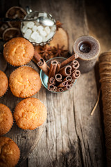 Muffins - sweet homemade cakes on a wooden kitchen table.