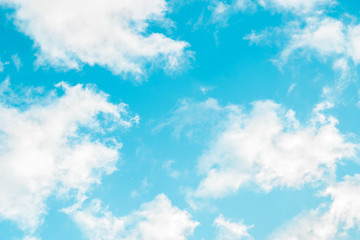 spring blue sky with fluffy clouds moved by the wind