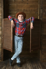 Boy in a plaid shirt and a  hat