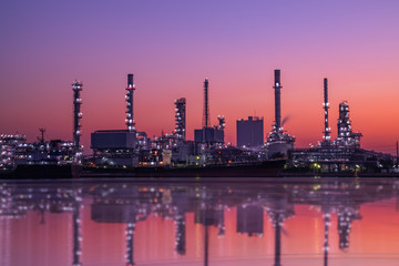 Fototapeta na wymiar Factory of petroleum industrial and Oil and gas refinery industry plant with glitter lighting and sunset in the night,Energy power station area.Gas storage tank in petrochemical factory with evening.