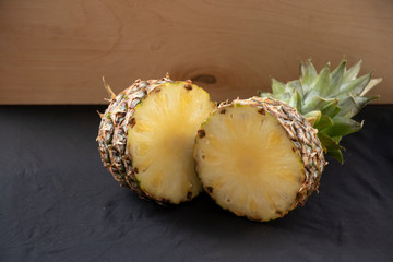 Big pineapple on a turquoise background. Juicy fruit - summer mood with bright colors. On white...