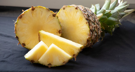 Big pineapple on a turquoise background. Juicy fruit - summer mood with bright colors. On white...