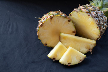 Big pineapple on a turquoise background. Juicy fruit - summer mood with bright colors. On white...