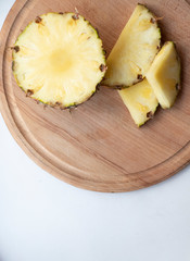 Sliced Pineapple on a turquoise background. Juicy fruit - summer mood with bright colors. On a...