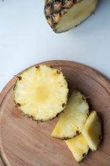 Sliced Pineapple on a turquoise background. Juicy fruit - summer mood with bright colors. On a...