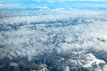 view of clouds and Alps mountains covered with snow