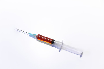 Fototapeta premium syringe and needle with orange vaccine