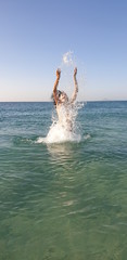 Woman throws water in the air