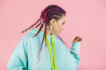 A girl with a fashionable set of multicolored braids Kanekalon. Colored artificial strands of hair. - obrazy, fototapety, plakaty