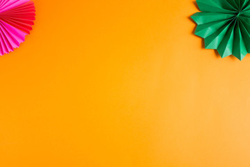 dark green decorative paper cigar on an orange textured background