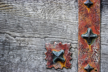 Old wooden board, background with elements of rusty wrought iron
