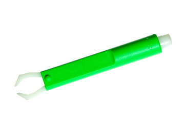 Green tick extractor / remover against white background