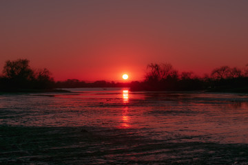 Fototapeta na wymiar red sunset by the river