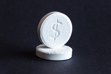 Two pills with dollar sign engraved